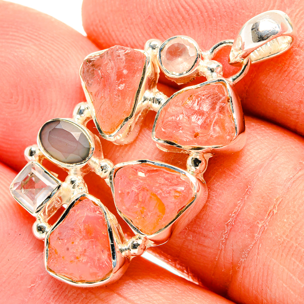 Sterling silver pendant closeup with pink-orange quartz, clear and gray stones