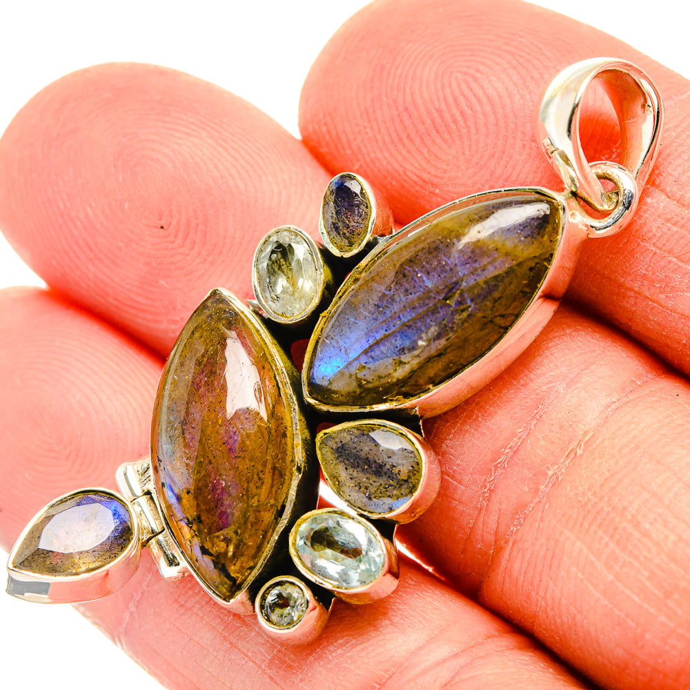 Sterling silver pendant with oval labradorite and small blue flash stones, bail loop