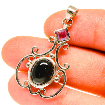 Sterling silver pendant with black onyx oval, square purple gemstone, ornate scroll setting