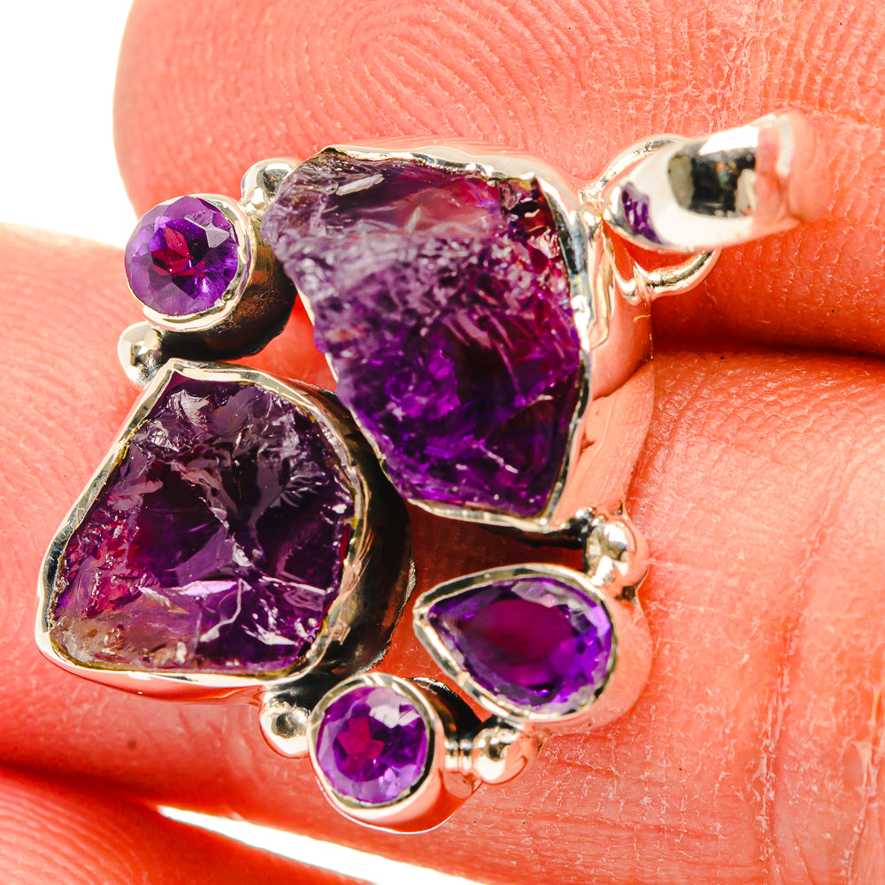 Rough amethyst pendant with purple faceted stones in sterling silver setting