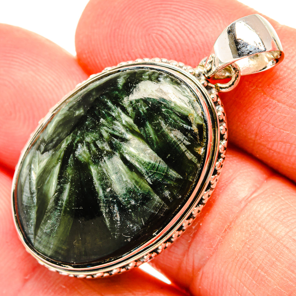 Oval seraphinite pendant with green gemstone cabochon in 925 silver bezel