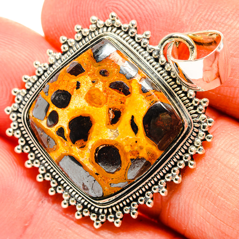 Sterling silver pendant close-up with rectangular orange bauxite in bezel and beaded border