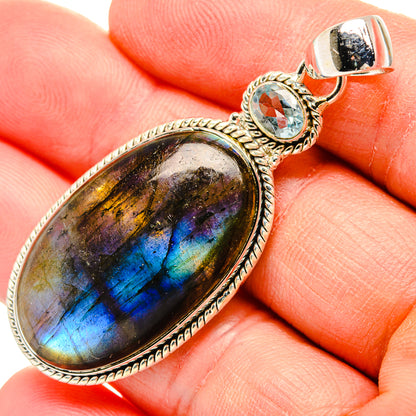 Oval labradorite pendant close-up with round blue topaz stone, 925 sterling silver