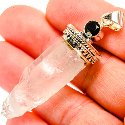Rough white quartz drop pendant with round black onyx detail in silver settings