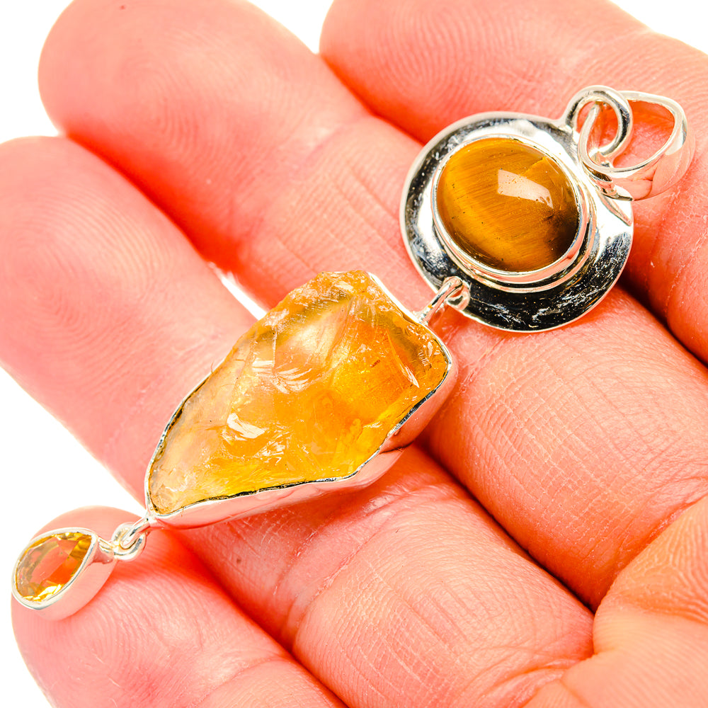 Sterling silver pendant close-up with rough citrine crystal and tiger eye cabochon