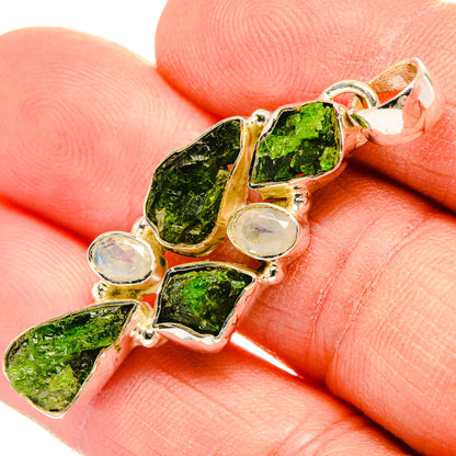 Sterling silver pendant close-up: rough green diopside stones with pale round moonstones