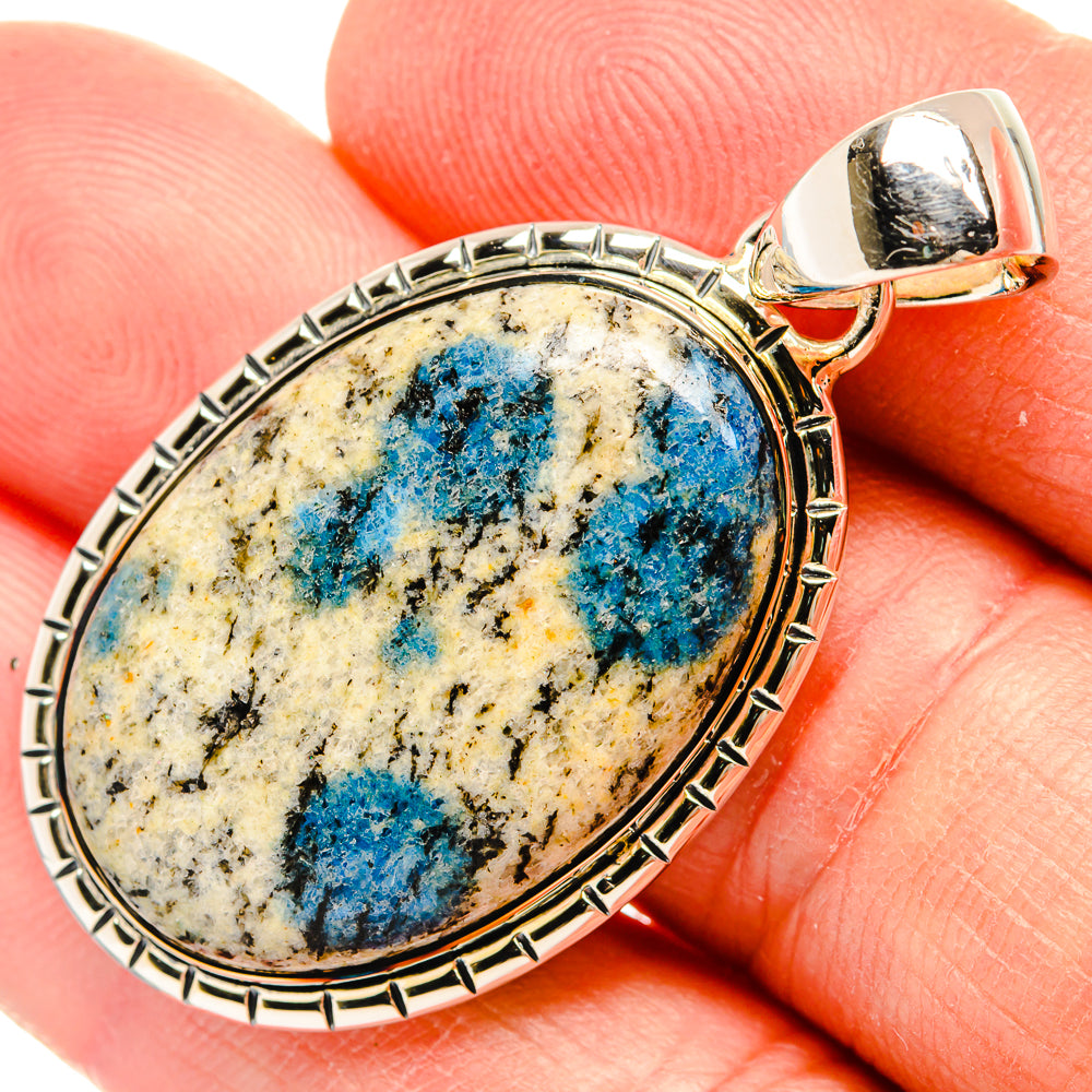 Sterling silver oval pendant with blue azurite center stone and top bail on finger