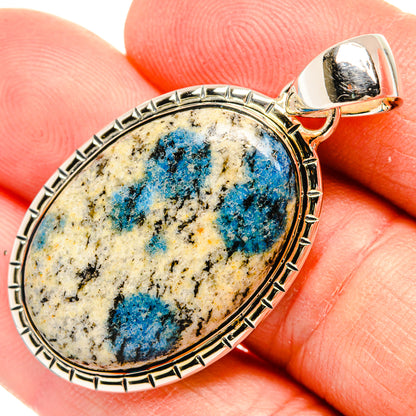 Sterling silver oval pendant with blue azurite center stone and top bail on finger