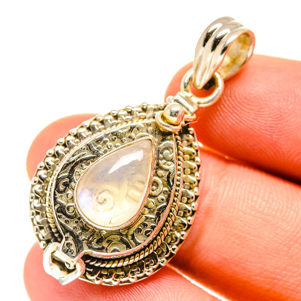 Teardrop moonstone pendant with ornate filigree bezel and top bail
