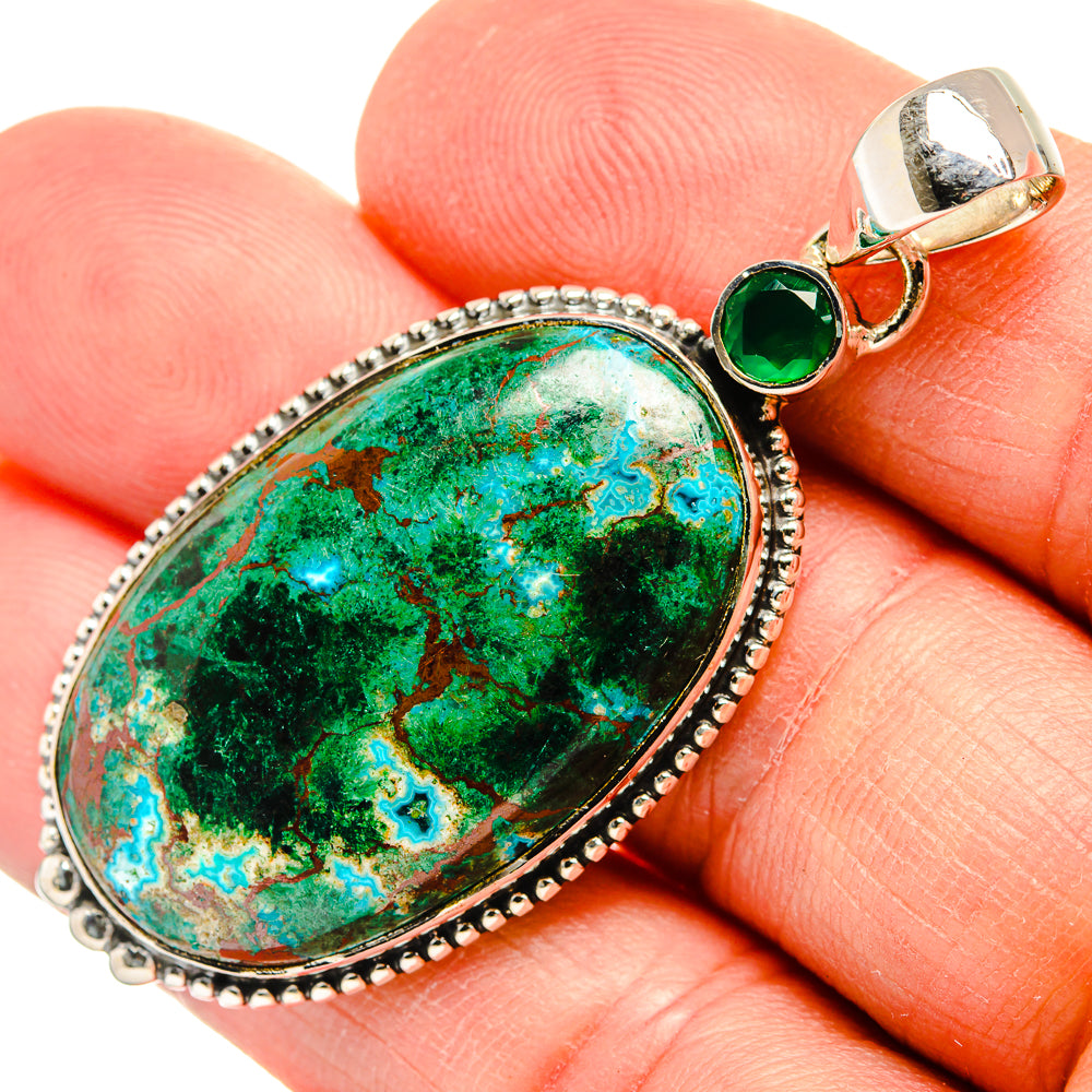 Close-up oval green stone pendant with beaded silver bezel and bail