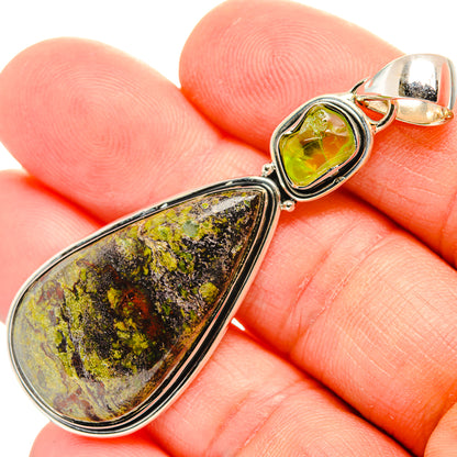 Sterling silver pendant close-up: green cabochon with mottled yellow teardrop stone