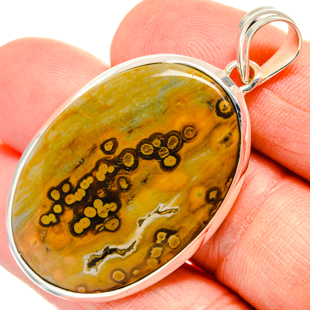 Ocean jasper oval pendant with sterling silver bezel and top bail, golden green stone.
