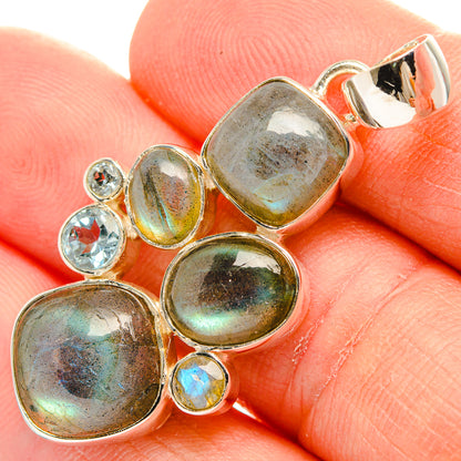 Closeup sterling silver labradorite oval pendant with blue topaz stones