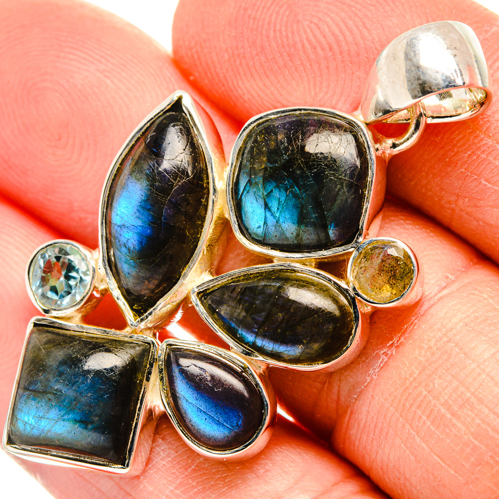 Sterling silver pendant cluster with blue multishape stones and small round topaz