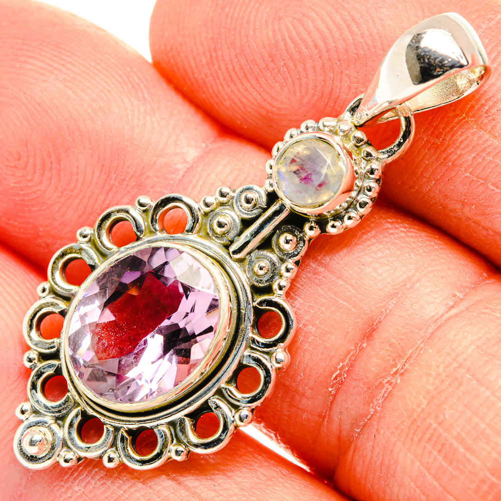 Close-up amethyst and moonstone drop pendant with decorative silver filigree