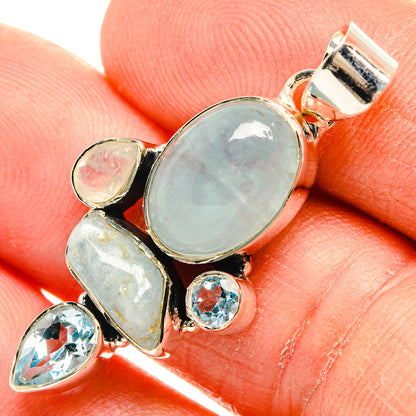Large oval blue opal-like center stone with smaller blue stones in sterling silver