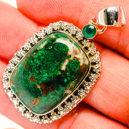 Close-up of green malachite oval pendant, silver halo bezel with round green accent stone