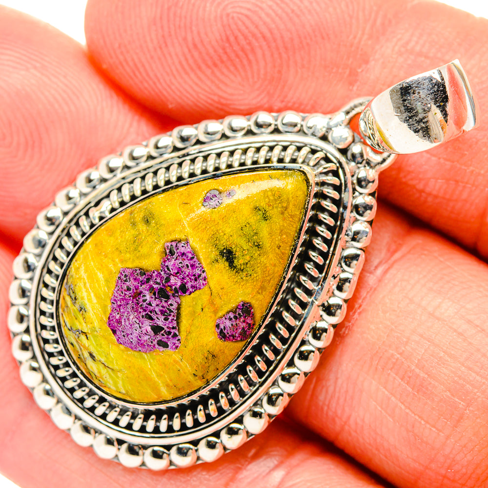 Pear-shaped sterling silver pendant with yellow and purple stone, beaded frame.