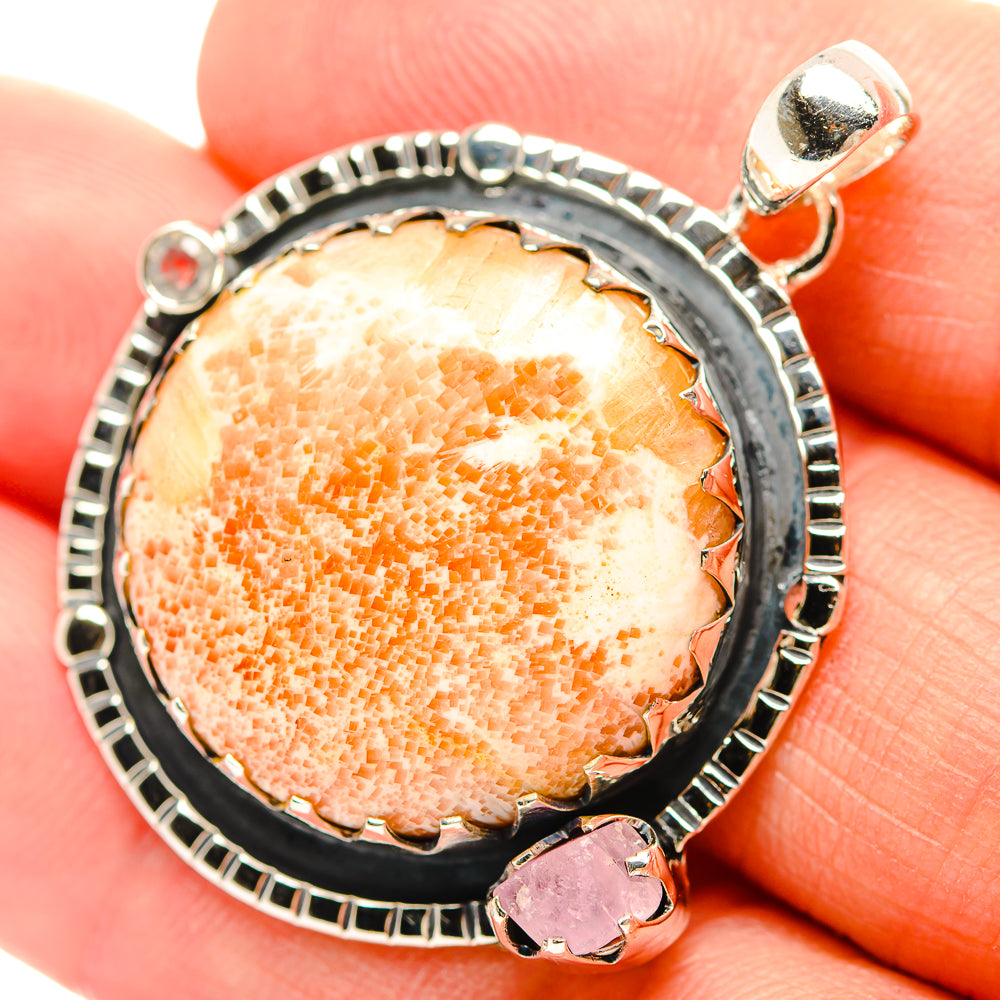 Sterling silver rose quartz pendant on bail with pink accent stone, close-up