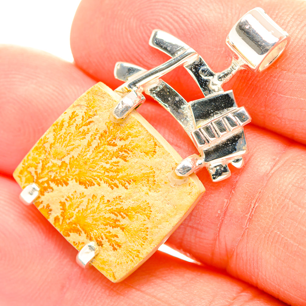 Orange dendrite psilomelane rectangle pendant in silver setting, close-up
