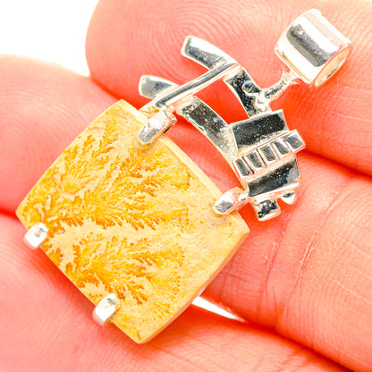 Orange dendrite psilomelane rectangle pendant in silver setting, close-up