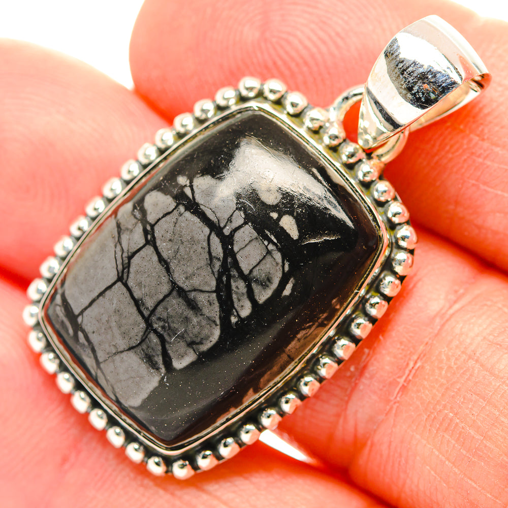 Sterling silver jasper pendant with black-and-gray crackled stone in oval bezel