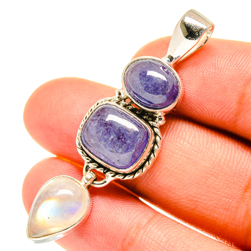 Sterling silver gemstone pendant with lavender oval and two rainbow moonstones on a finger