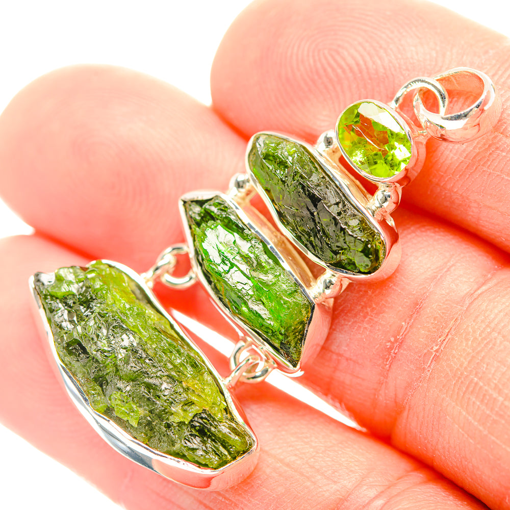 Sterling silver pendant with two rough green gemstones and side halo accents