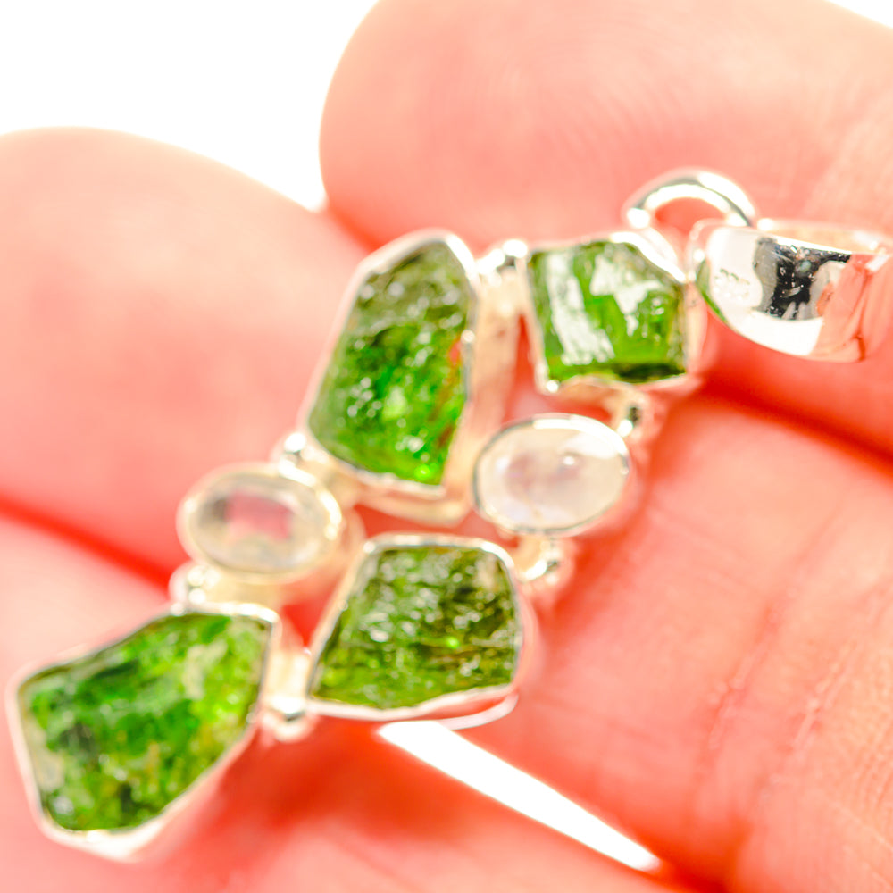 Sterling silver pendant close-up with rough green diopside stones and round moonstone cabochons