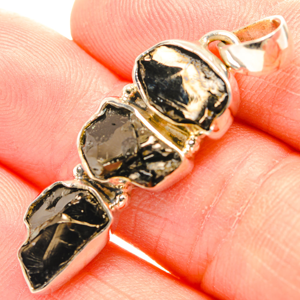 Rough shungite pendant close-up showing three rough black stones in silver bezels