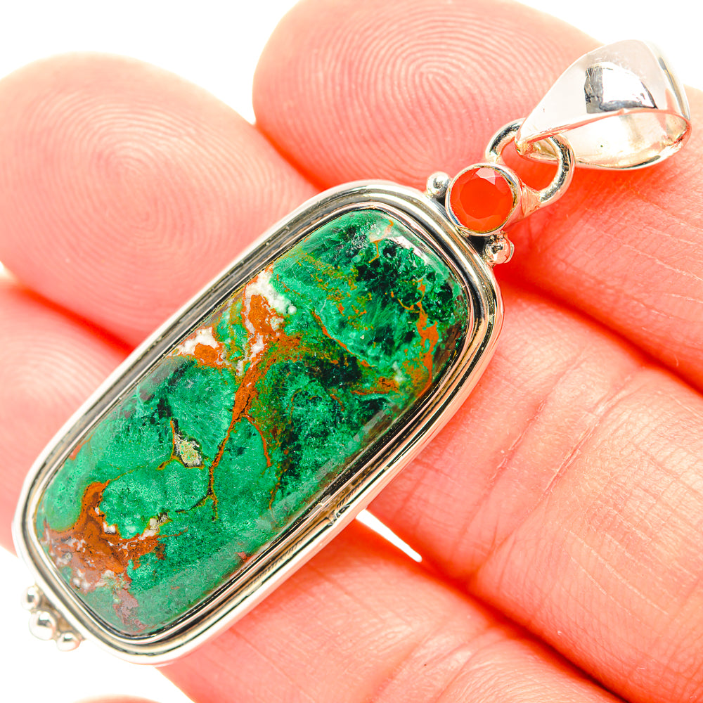 Oval chrysocolla pendant with green stone, silver bezel, and orange accent at top