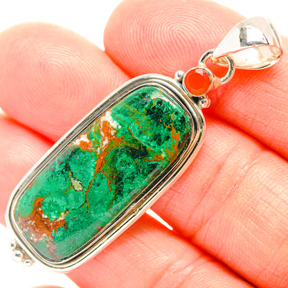Oval chrysocolla pendant with green stone, silver bezel, and orange accent at top