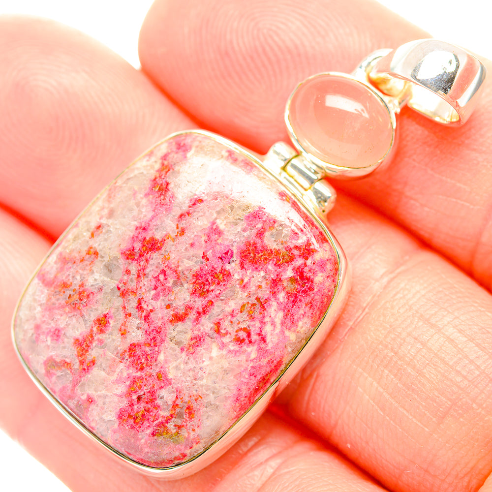 Pink speckled rose quartz pendant close-up, silver bail and bezel on top