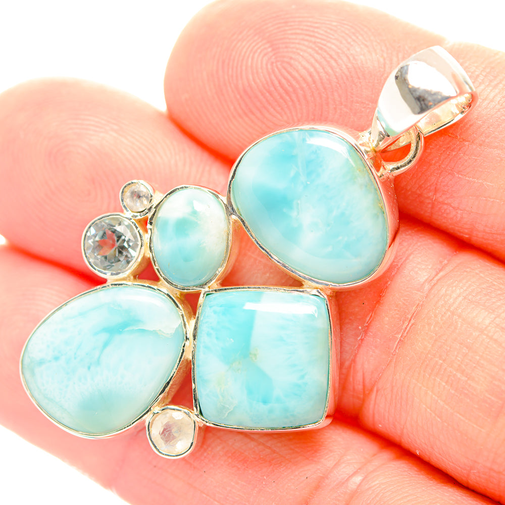 Blue gemstone pendant detail with sterling silver bail and bezel-set cabochons