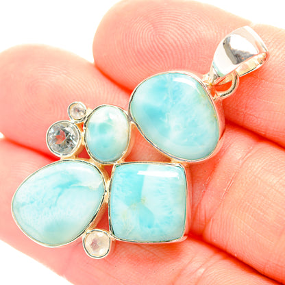 Blue gemstone pendant detail with sterling silver bail and bezel-set cabochons
