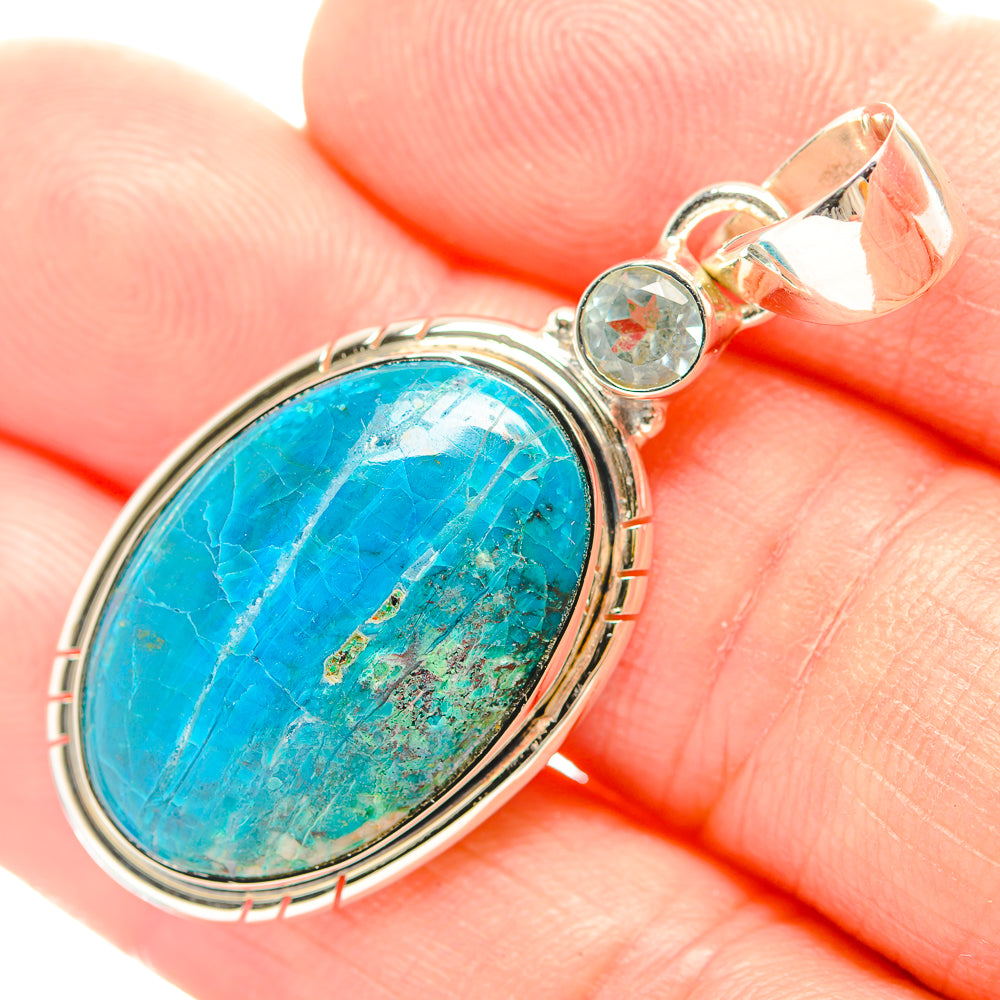 Close-up: turquoise oval pendant with sterling silver setting and small round clear stones