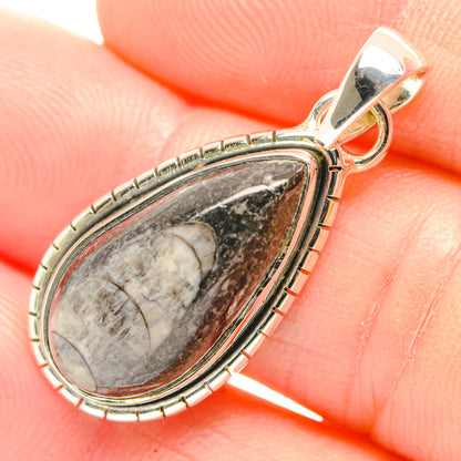 Sterling silver teardrop fossil pendant close-up with marbled gray stone and bail