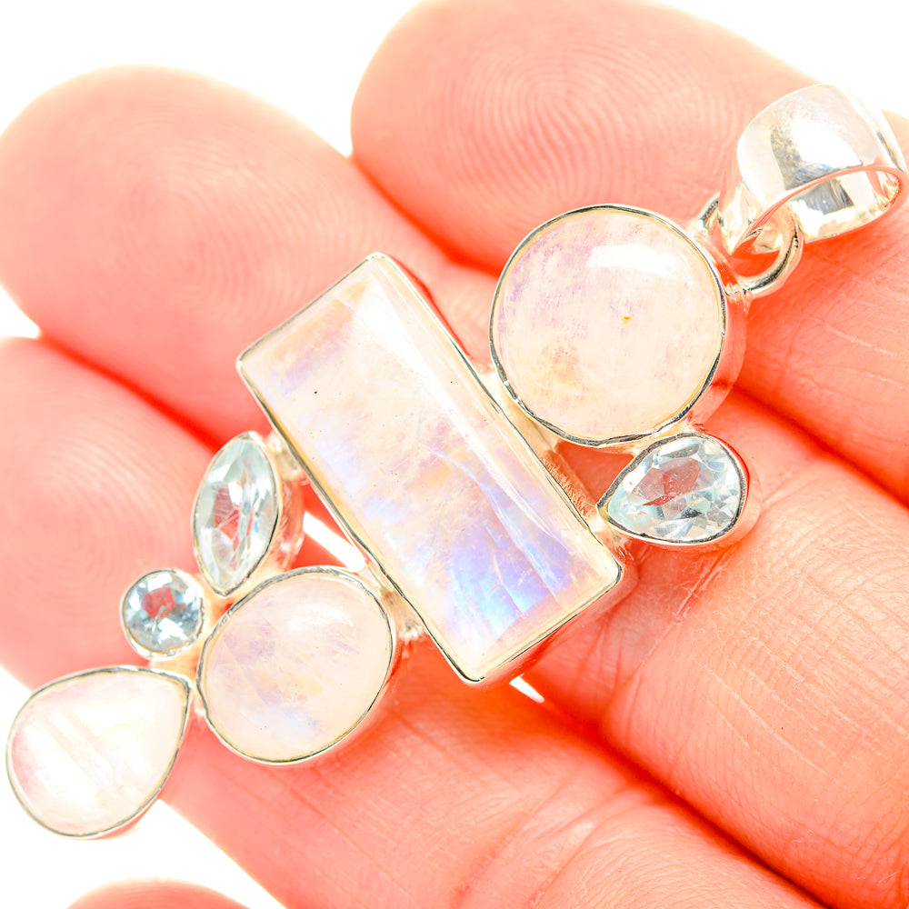 Sterling silver pendant with rainbow opal-like stones and blue accent stones, loop bail
