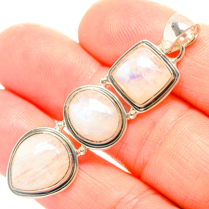 Opalescent moonstone link pendant in polished sterling silver, close-up on hand