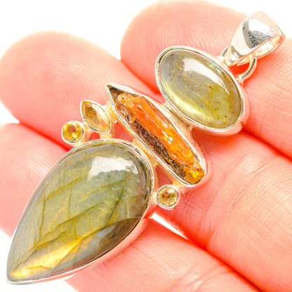 Sterling silver pendant with green cabochon stones and orange crystal, with yellow accents