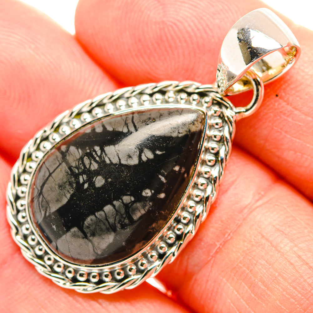 Sterling silver jasper pendant close-up with loop bail and ornate edge around black drop