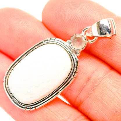 Oval white gemstone pendant with beaded silver frame and small round pink stone top