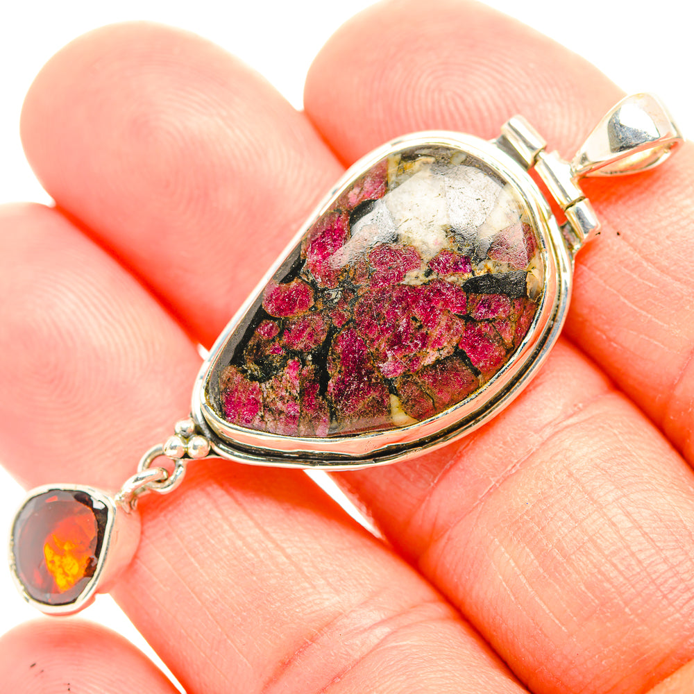 Silver pendant with marbled cabochon stone and two orange round gemstone drops