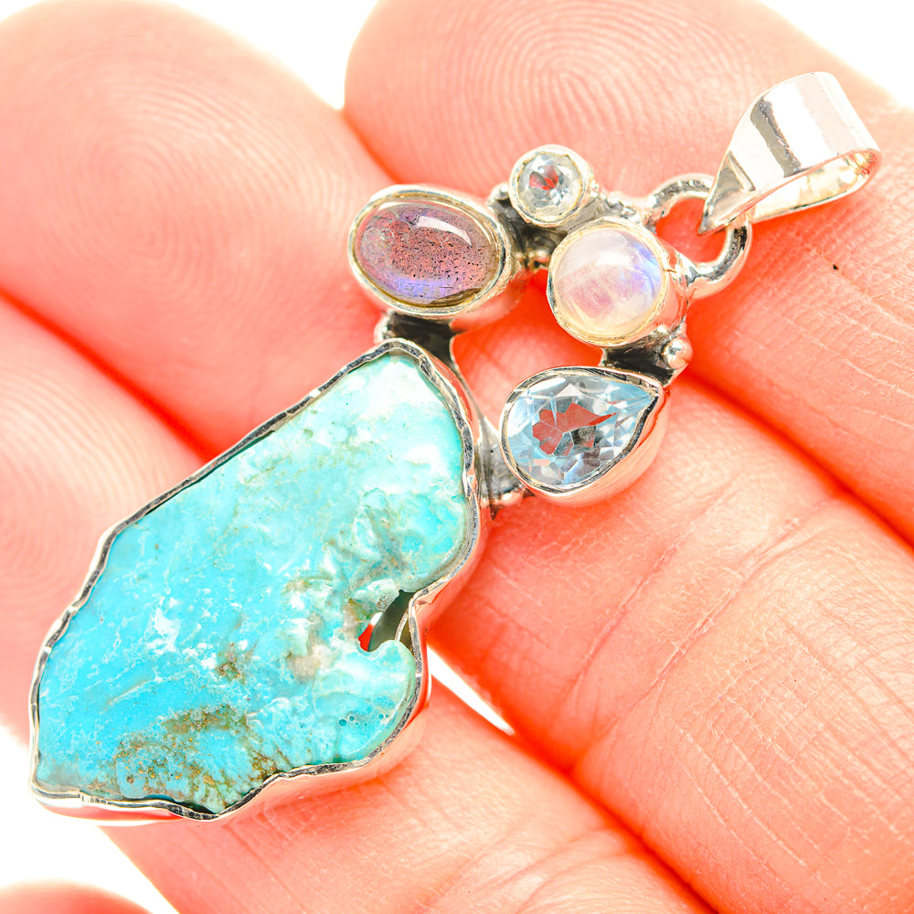 Sterling silver gemstone pendant with rough turquoise stone and small opal-like charms