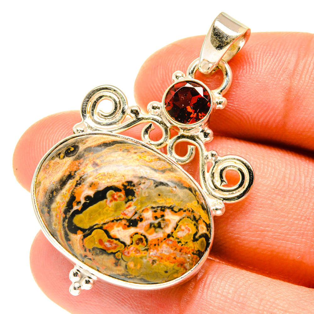 Oval poppy jasper pendant with red round gemstone, 925 sterling silver bail on hand