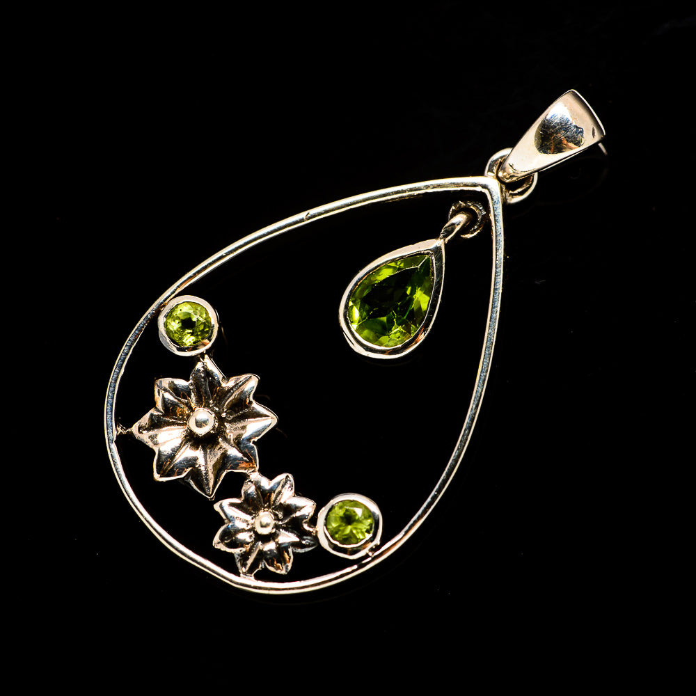 Sterling silver teardrop pendant with green peridot stones and star accents