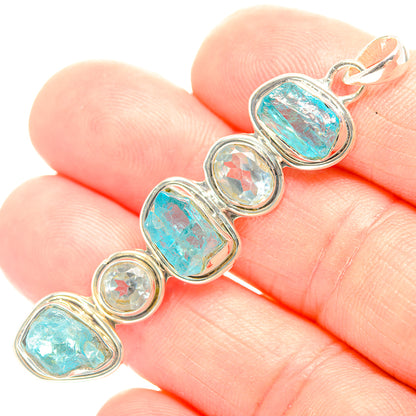 Sterling silver pendant with five bezel-set blue and clear stones and a bail loop