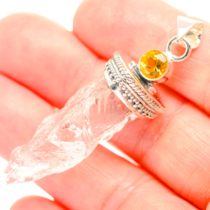 Sterling silver citrine and quartz pendant on hand, round citrine in prong bezel