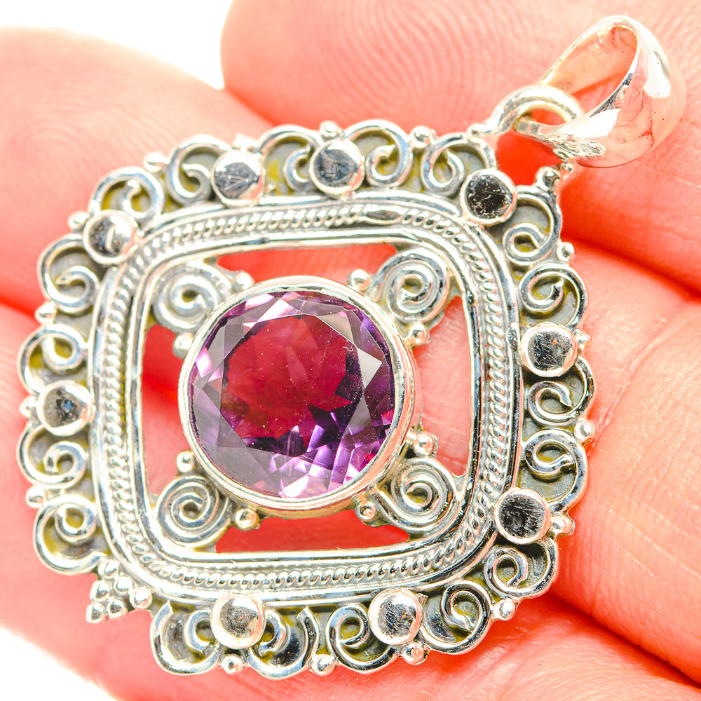 Sterling silver amethyst pendant with faceted purple gemstone and filigree frame