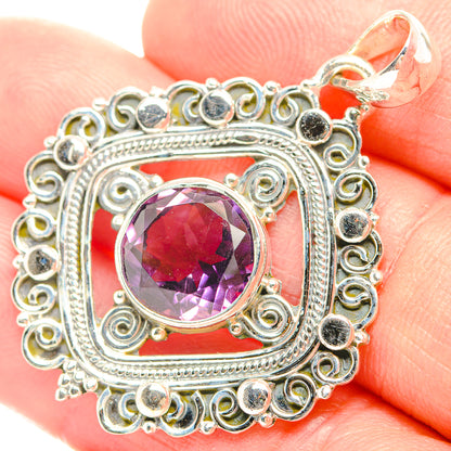 Sterling silver amethyst pendant with faceted purple gemstone and filigree frame